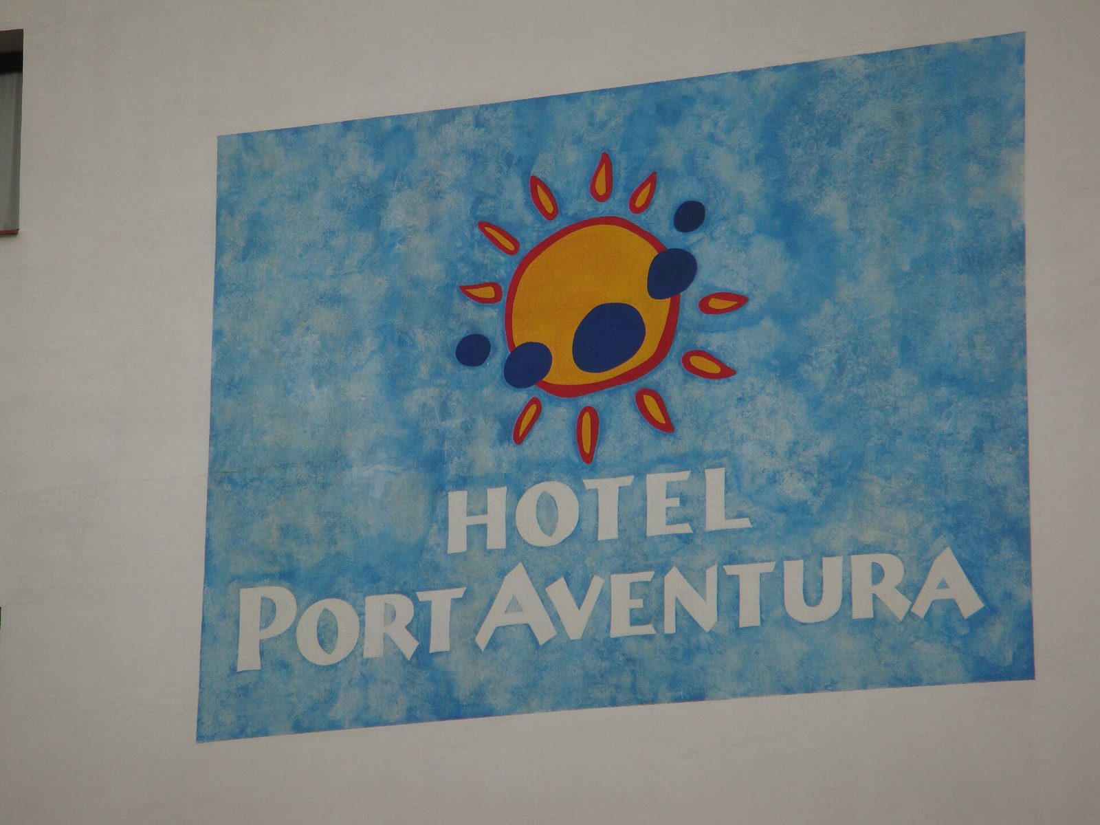 The painted Hotel PortAventura sign on the wall of the resort hotel at PortAventura World, Salou